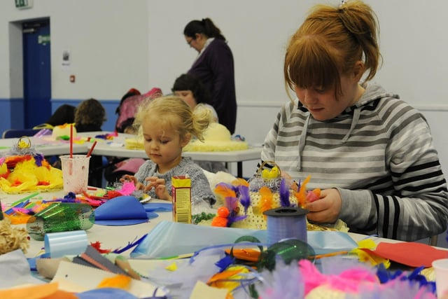 Sisters Ruby Moore, aged three and Kayleigh Moore, 10, take part in a bonnet making workshop at Manton Centre for Sport and Learning, in Worksop.