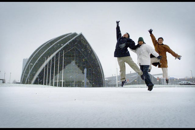 Catalino Linogao, Cherry Linogao, and Froilan Guanzon - all from Manilla, Phillipines - enjoy their first ever snowfall in 2002.