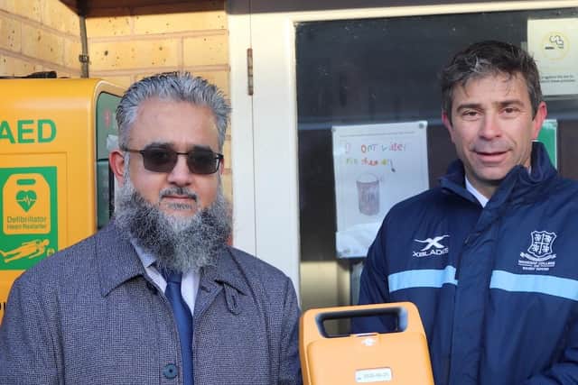 Vice chairman of Muslim Charity, Bakhtyar Pirzada hands over a defibrillator to Ranby House School headteacher, David Thorpe.