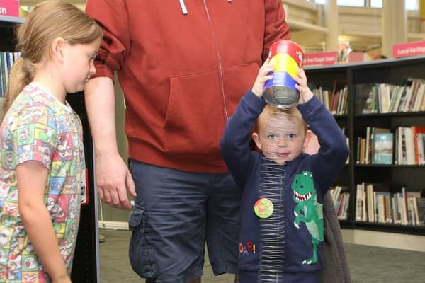 Worksop Library Fun Palace, Sterling shows sister Caitlin and dad Simon Nicholass what to do in the science area.