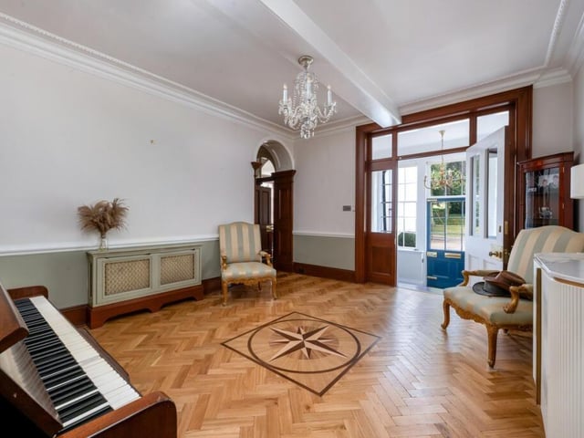 An entrance hall with parquet flooring.
