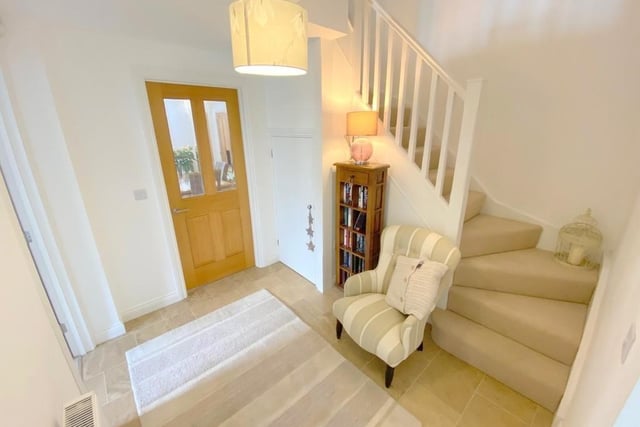 The welcoming entrance hallway boasts an under-stairs storage cupboard. The staircase, of course, leads us to the first floor of the £320,000 property.