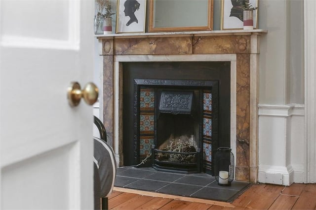 Period fireplace in bedroom.