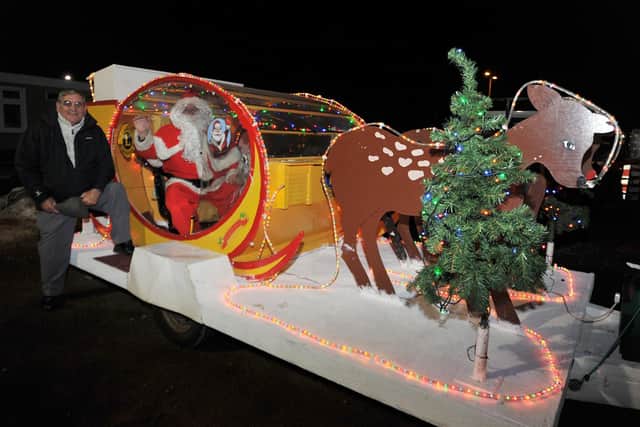 The Worksop Lions Christmas sleigh. Pictured is former Worksop Lions president  Bill Maddison with Santa and the sleigh.