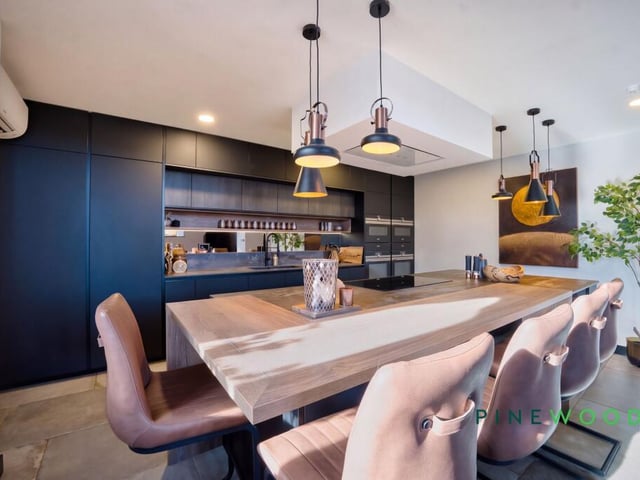 The modern kitchen features handleless cabinetry.