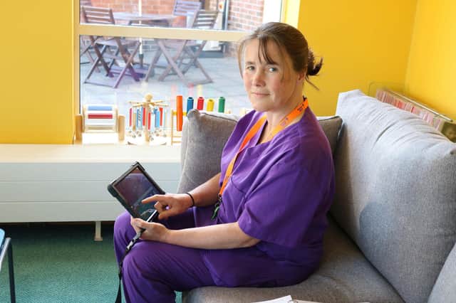 Bluebell Wood Nurse Sally Howe trying out one of the new tablets.