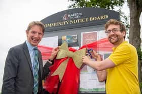 Harron Homes' Sales Manager Paul Walters unveiling the Laughton Gate noticeboard with MP Alexander Stafford
