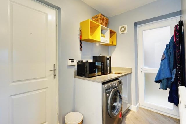 There is space and plumbing for a washing machine in the utility room, which sits conveniently next to the kitchen. It is fitted with a range of wall and base units, work surfaces and inset sink.
