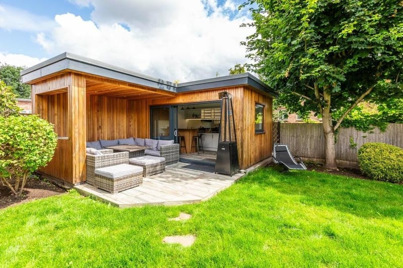 Let's look at a few shots of the garden at the £750,000 property now, starting with the expertly-built summerhouse, which comes complete with covered seating areas and a fitted bar.