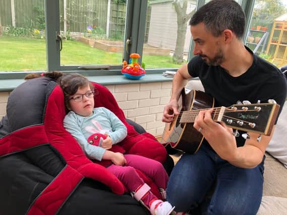 Five-year-old Ella and her dad, Mat, enjoying music at home during lockdown.