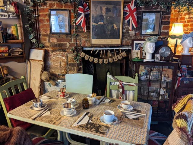 The Dish Detective took a trip back in time while enjoying the sandwiches and cake at 19 Fourteas. The reviewer said: 'Walking through the front door is like stepping into another era. Inside, the walls are decorated with Home Front posters, old photographs, and Union Flags, while teddy bears, ration books, crockery, pots and pans, antique clocks and radios cover every surface.'