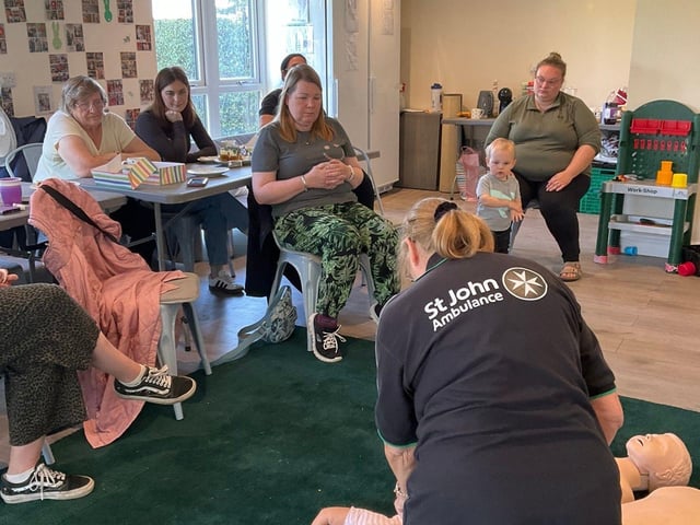 Demonstrating CPR on a baby