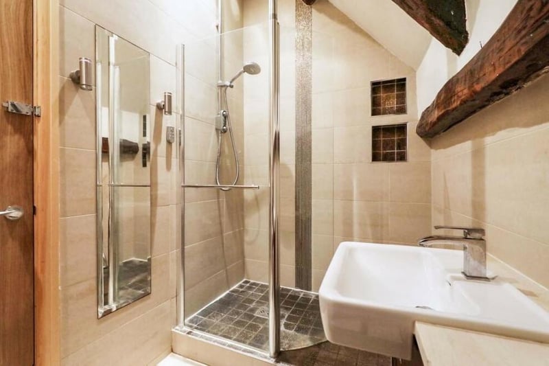 The Granary contains two shower rooms, including this one which is fitted with a three-piece suite. As well as a shower enclosure, there is a vanity wash hand basin, a WC and tiled walls and floor.