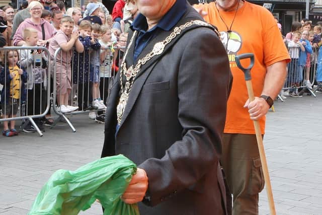 Worksop mayor, councillor Tony Eaton, joins in with one of the dinosaur shows by being on poo duty.