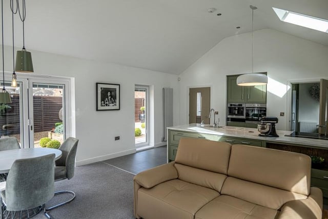 Here is the luxurious open-plan area from a different angle. In the foreground is the living space, to the left is the dining area and in the background is the kitchen.
