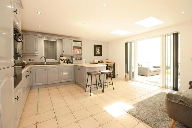 It's a kitchen that offers more. The room boasts a small living area and also opens out into the conservatory.