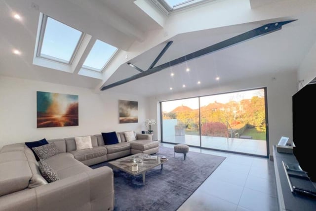 Probably the best place to start our tour of the £515,000 house is this stunning sitting room, which has been extended. Brightness is guaranteed thanks to large aluminium patio doors that lead out to the back garden and four Velux windows with electrically-controlled blinds.