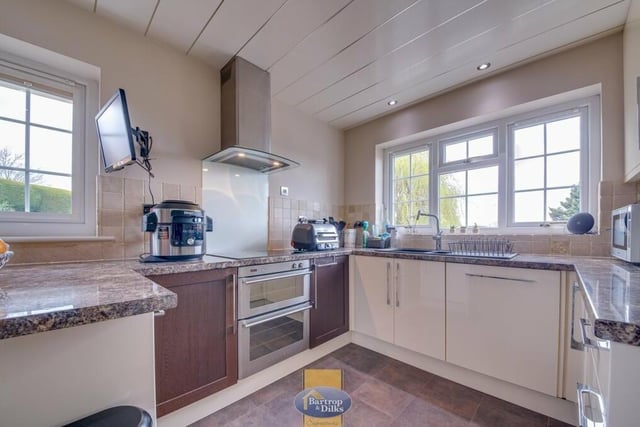 Next stop on our tour of the £700,000 property is this delightful, fitted breakfast kitchen. Integrated appliances include an electric hob, double oven and dishwasher, while there is also a bowl-and-a-half sink unit with mixer tap.