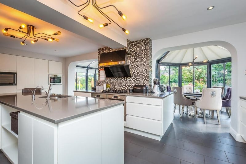 Next stop at the £750,000 Sparken Hill property is this superb open-plan living kitchen, which is fitted with a comprehensive range of high-gloss base and wall units. As you can see, It flows seamlessly into a garden room.