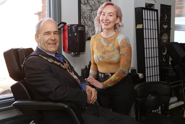 Tattoo artist Faye Skinner with mayor Tony Eaton in the tattooist's chair.