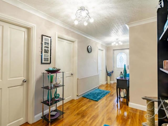The bungalow's bright and welcoming hallway gives access to all the rooms. It has laminate flooring, a central heating radiator and plenty of room for ornaments or plants.