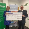 Kate Lightfoot, corporate partnerships manager at Macmillan Cancer Support, received the latest donation from Frank Meilack, director of community engagement at Memoria Ltd.