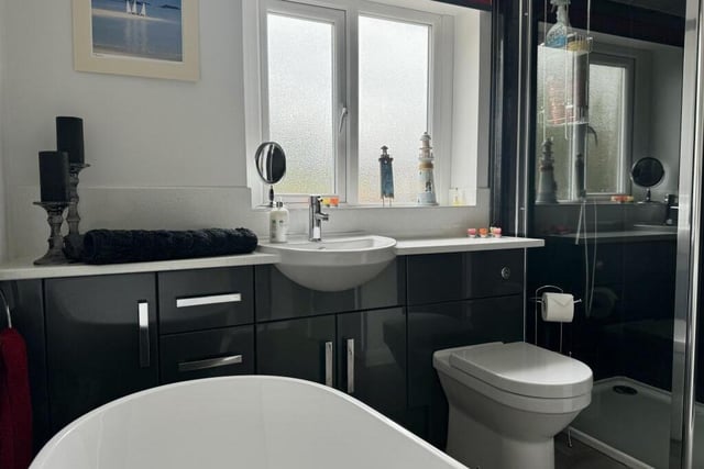 The first floor houses the family bathroom, which consists of a four-piece suite. It includes a walk-in shower, a wash hand basin set into a vanity unit, and a WC