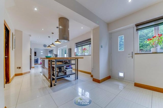 This shot underlines what a super size the breakfast kitchen as it spans three-quarters of the width of the rear of the house. The floor is tiled and at the far end is an archway through to the dining room.