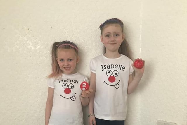 Sisters, seven-year-old Isabelle, and four-year-old Harper, both posed with their personalised tops and red noses.