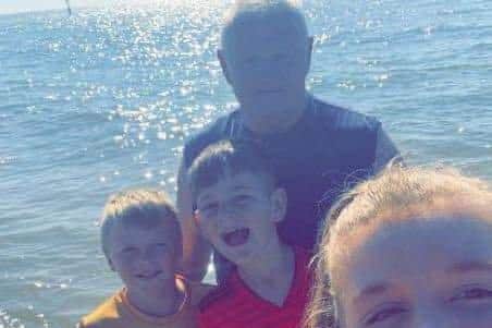 Andy Drobinca, aged 60, pictured with his grandchildren. Lucy, Leo and Caiden 
