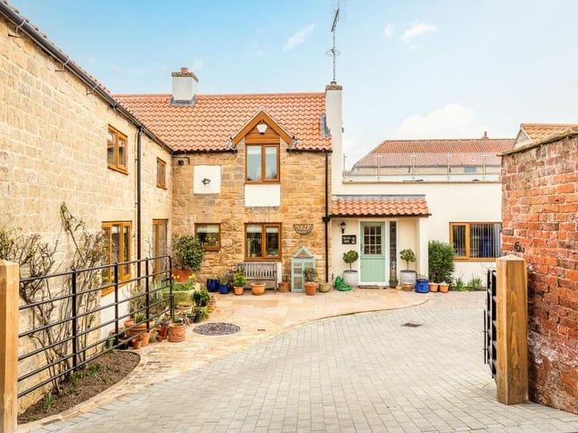 The entrance to the £650,000 property is through wrought-iron gates on to a block-paved parking area.