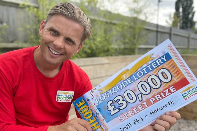 Lottery ambassador Jeff Brazier with one of the Harworth winners cheque
