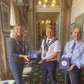 Mayor of Cirencester Claire Bloomer presenting Worksop Mayor Tony Eaton and Bassetlaw District Council chairman Jack Bowker with a civic gift.