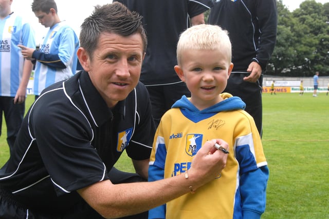 Stags Captain Ryan Williams signs the shirt of four year old Coran Woodham at Field Mill.