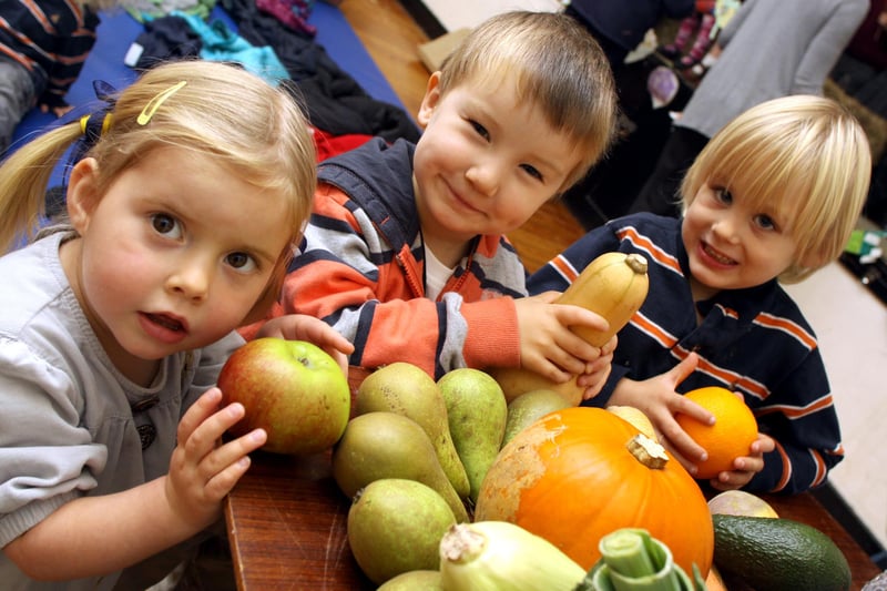 Rose Henning, Harry Goodley, and Alfie Buxton from Holloway Playgroup take part in a harvest festival in 2010.