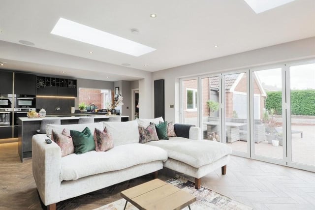 The ground floor of the £695,000 Blyth property is largely open-plan, with areas sectioned into specific zones. Here the kitchen backs on to a living space in the foreground that has large bi-folding doors, which lead into the garden.