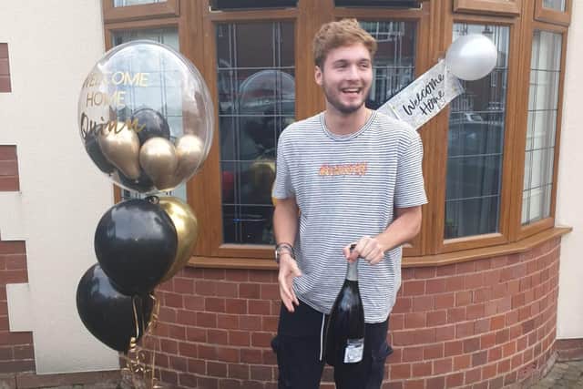Quinn celebrates outside his Worksop home after finally returning home