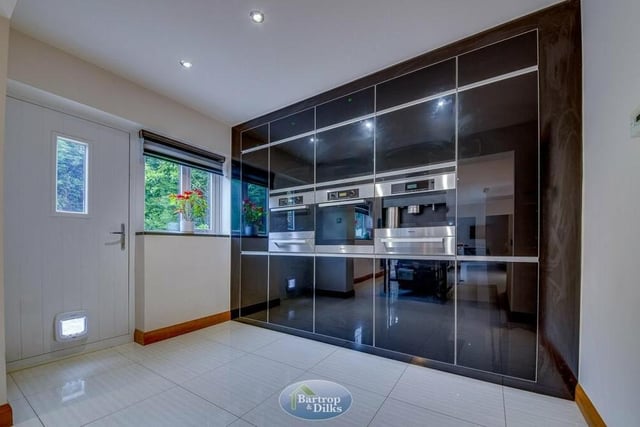 A shining example of the superb fixtures and fittings at the Ash Close house is this floor-to-ceiling stunner in the breakfast kitchen. It features units with larder storage and integrated appliances including a Miele oven and microwave with plate-warmer.
