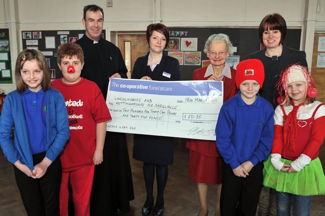 Children at St Augustine's Primary School took a break from the Red Nose Day fun to present a cheque to Notts and Lincs Air Ambulance.
Picture includes Emily Jackson, eight, Harvey Moore, 10, Jack Pettinger, 10, Rosie Parry, nine, Father Spicer, Joanna Jackson, Co-Op Funeral Care, Sue Halpin, Air Ambulance and Jackie Ryan, headteacher,