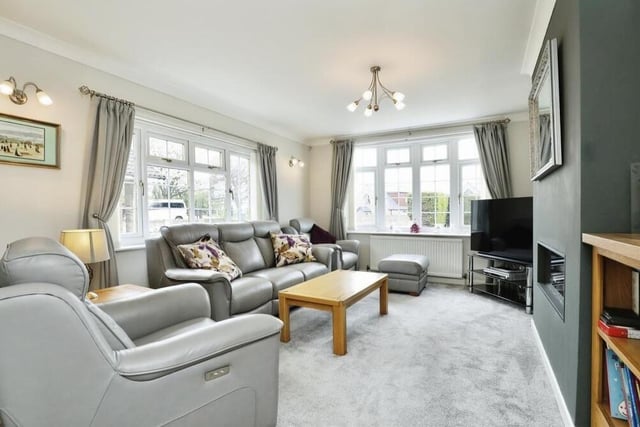 The first room we look at inside the £400,000-plus property is this comfortable lounge or living room. It is naturally bright thanks to double-glazed windows facing the front and side of the bungalow.