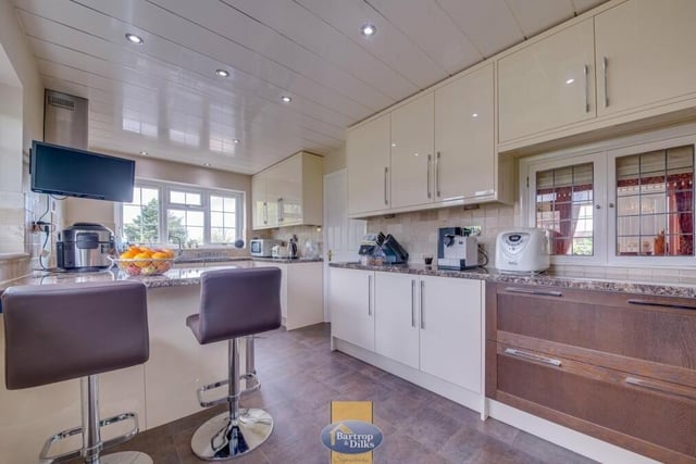 The sparkling kitchen also features a breakfast bar, gloss fitted wall and base units, work surfaces, downlights and windows facing the front and side of the Park Place bungalow.