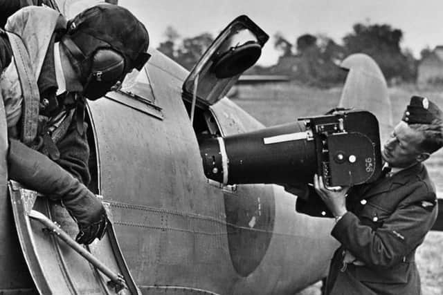 A Photo Reconnaissance Spitfire is loaded with a vertical camera prior to a mission over occupied territory.