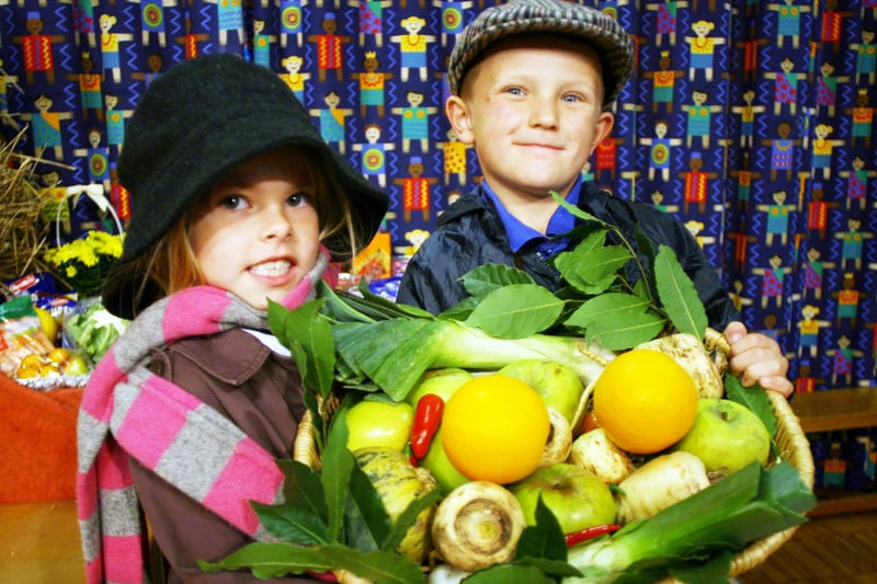 Chloe Robinson and Lewis Dawn with a basket of fruit and vegetables for Lenthall Infants School's harvest festival in 2008.