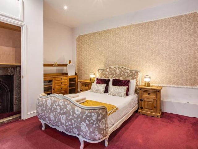 Feature fireplaces abound throughout the property, including in this bedroom, which also features its own en suite shower.