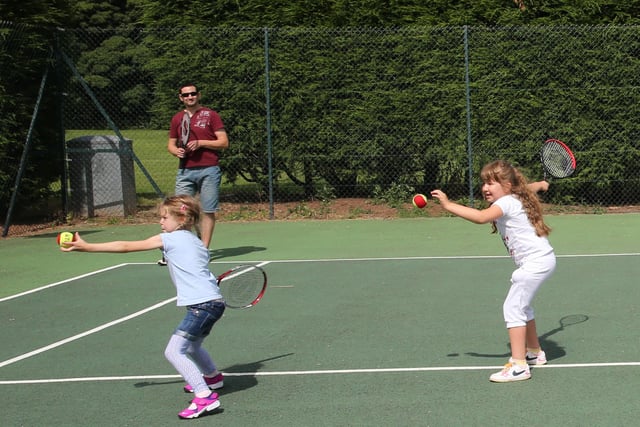 Paul Parry watches on as Ceryn Greaves, age 5, and Millie Parry, age 8, learn some skills.