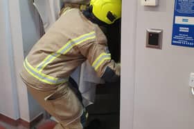 A Nottinghamshire firefighter demonstrates one of the new smoke curtains