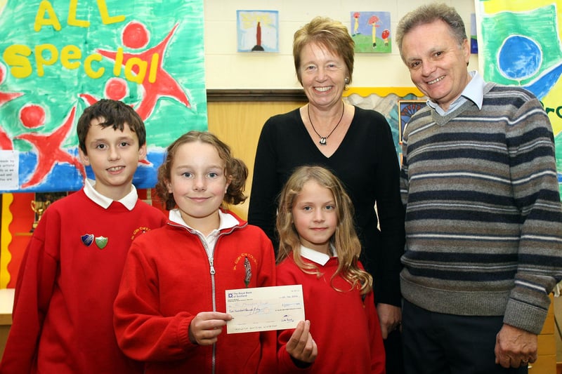 St Giles Primary School pupils Tim Coates,10, Emma Hallam,10, and Rebecca Doxey,10, present a cheque for £200 raised from the 2006 harvest festival collection to Mary and Steve Bacon for the Meetse A Bophelo School in Mamelodi, Pretoria.
