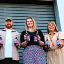 Showing off the special purple bottles are, from left: Matt Davies (Henderson's general manager), artist Luke Horton, Pip Colley and Ruth Wallbank (both Bluebell Wood). Photo: Submitted