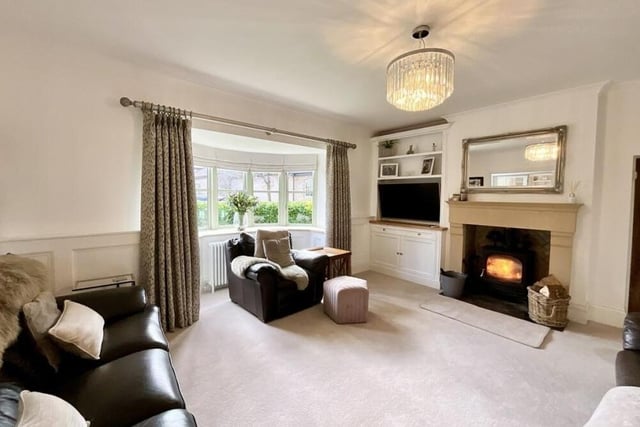 The focal point of the lounge at the £895,000 farmhouse is a traditional fireplace, with a log-burning stove.