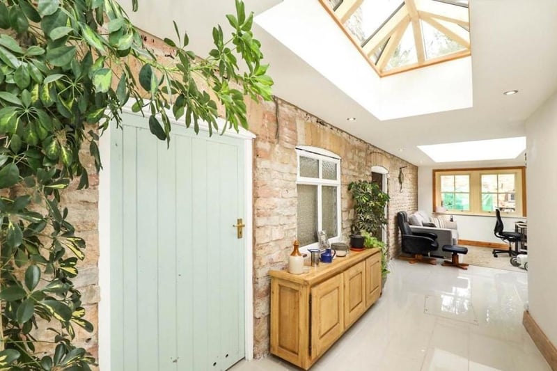 The long and narrow orangery gives the £625,000 property a sleek touch, especially with its porcelain tiled floor and two ceiling lanterns. There is plenty of room for furniture, while double doors lead out to a walled garden.